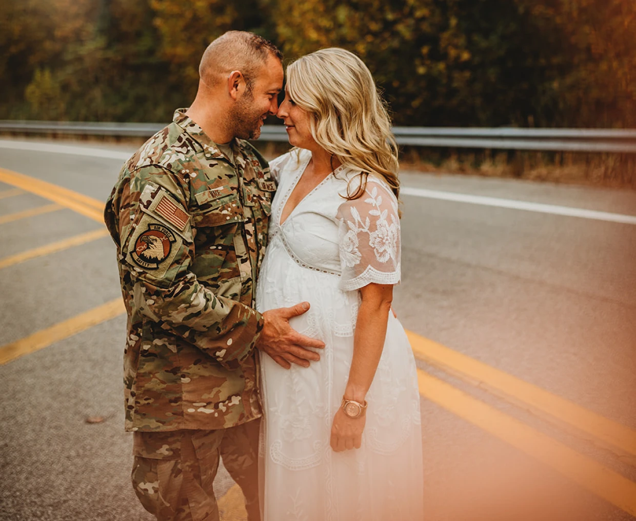 Soldier embraces pregnant woman on road